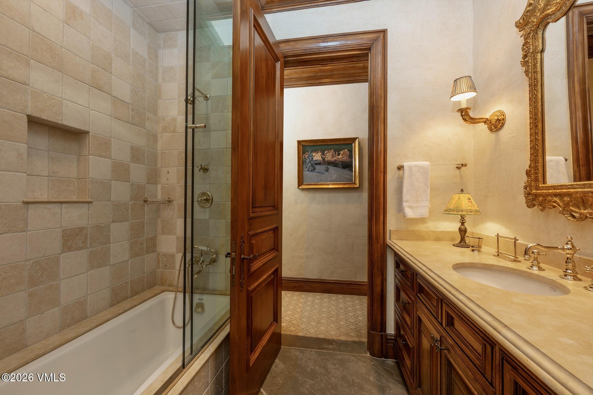 677 Pilgrim Drive Edwards, CO 81632 - Photo 39 of 64 a bathroom with a granite countertop sink a mirror and shower