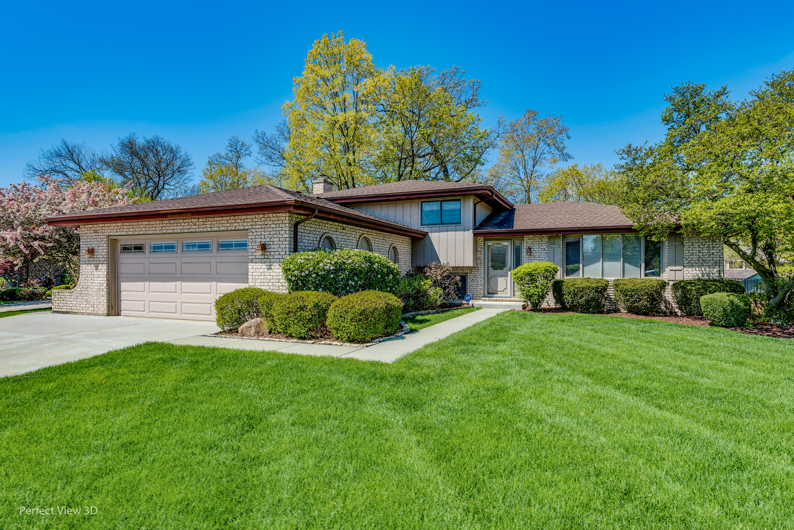 a view of a house with a yard and sitting area