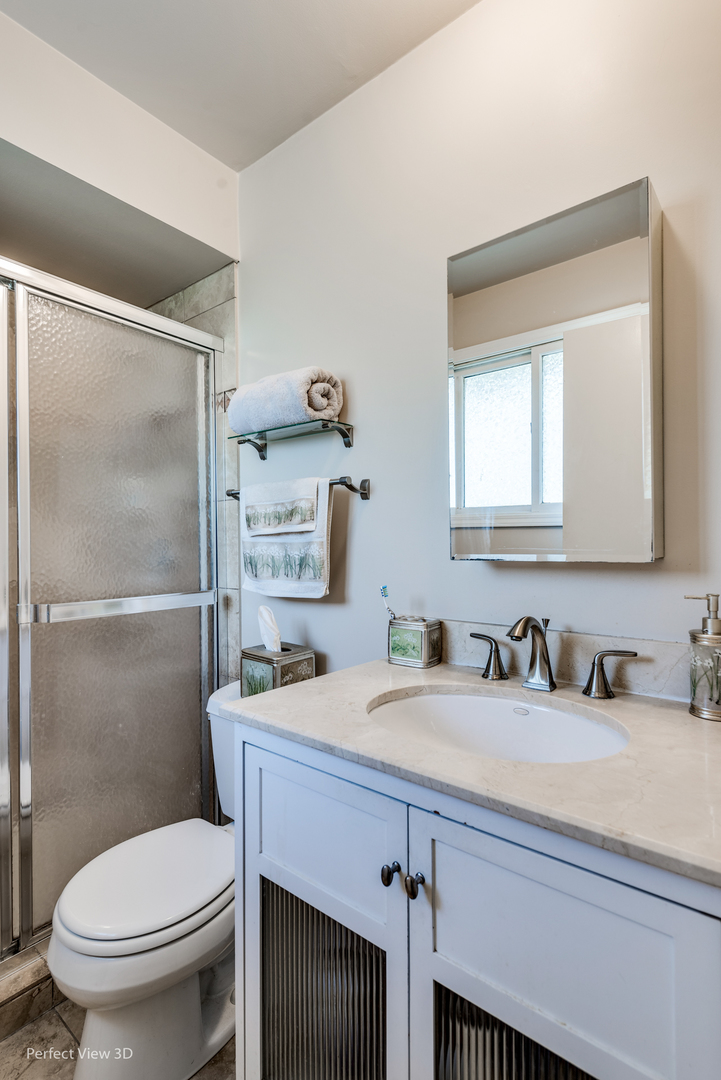 586 Siems Circle Roselle, IL 60172 - Photo 16 of 25 a bathroom with a sink toilet and mirror