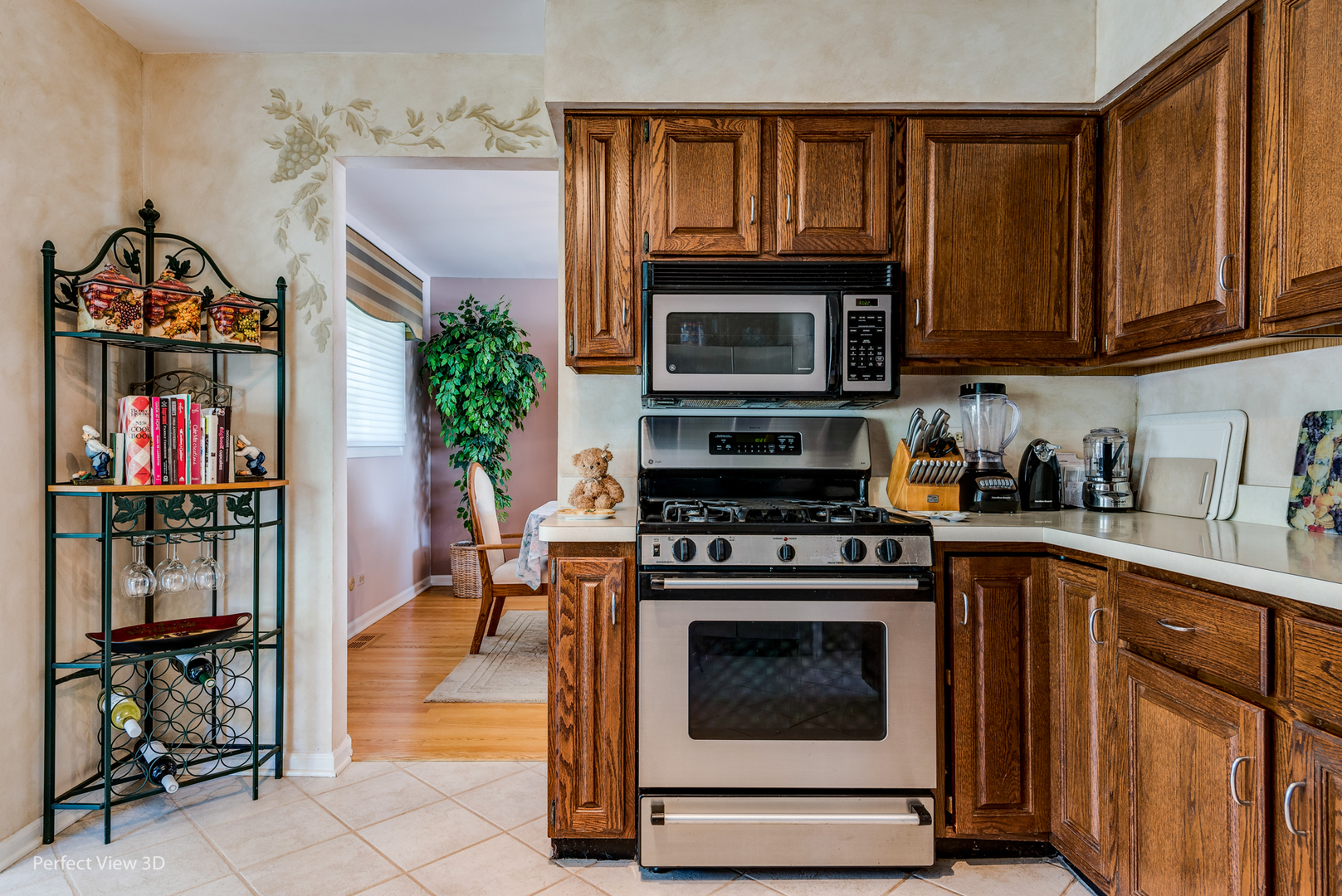 586 Siems Circle Roselle, IL 60172 - Photo 8 of 25 a kitchen with granite countertop wooden cabinets stainless steel appliances and a counter space