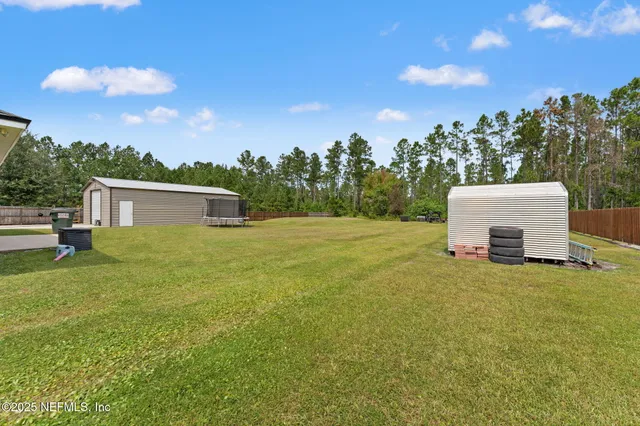 a view of a house with a backyard