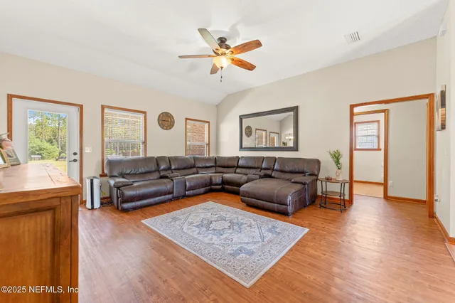 a living room with furniture and wooden floor