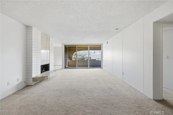 a view of empty room with a fireplace