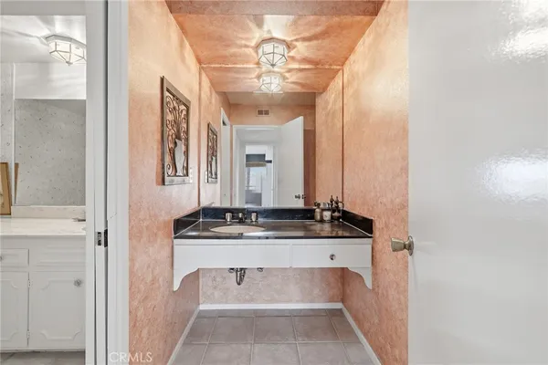 a bathroom with a tub a sink and mirror