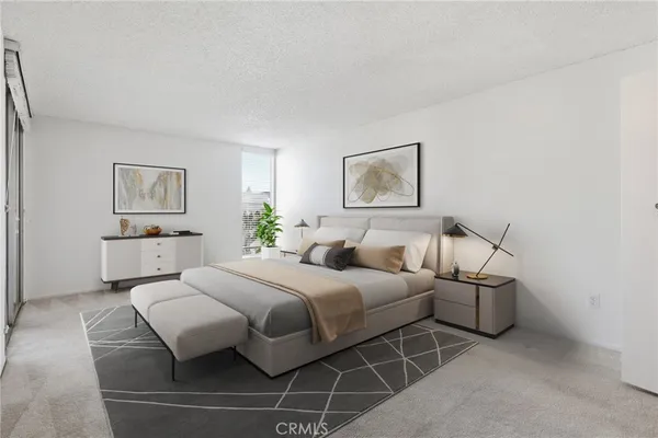 a room with a bed and a view of couch