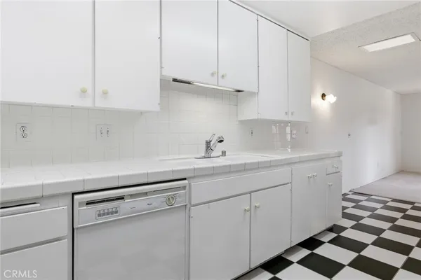 a kitchen with appliances cabinets and a sink