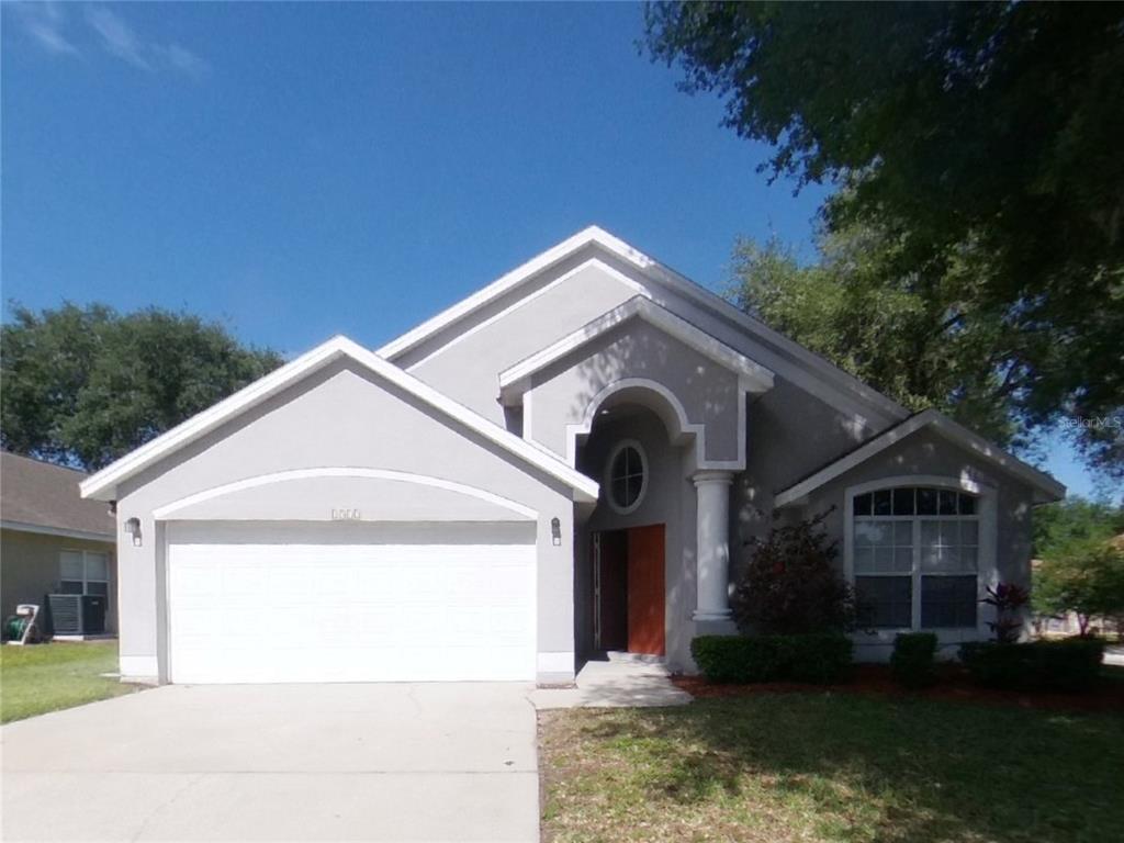 2512 Meadow Oaks Loop Clermont, FL 34714 - Photo 1 of 1 a front view of a house with a yard