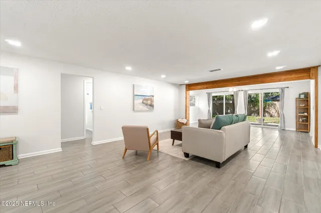 a living room with furniture and wooden floor