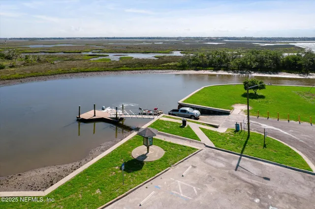 an aerial view of a house with a garden and lake view