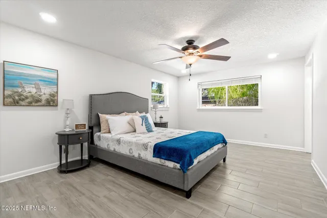 a living room with a bed furniture and a window