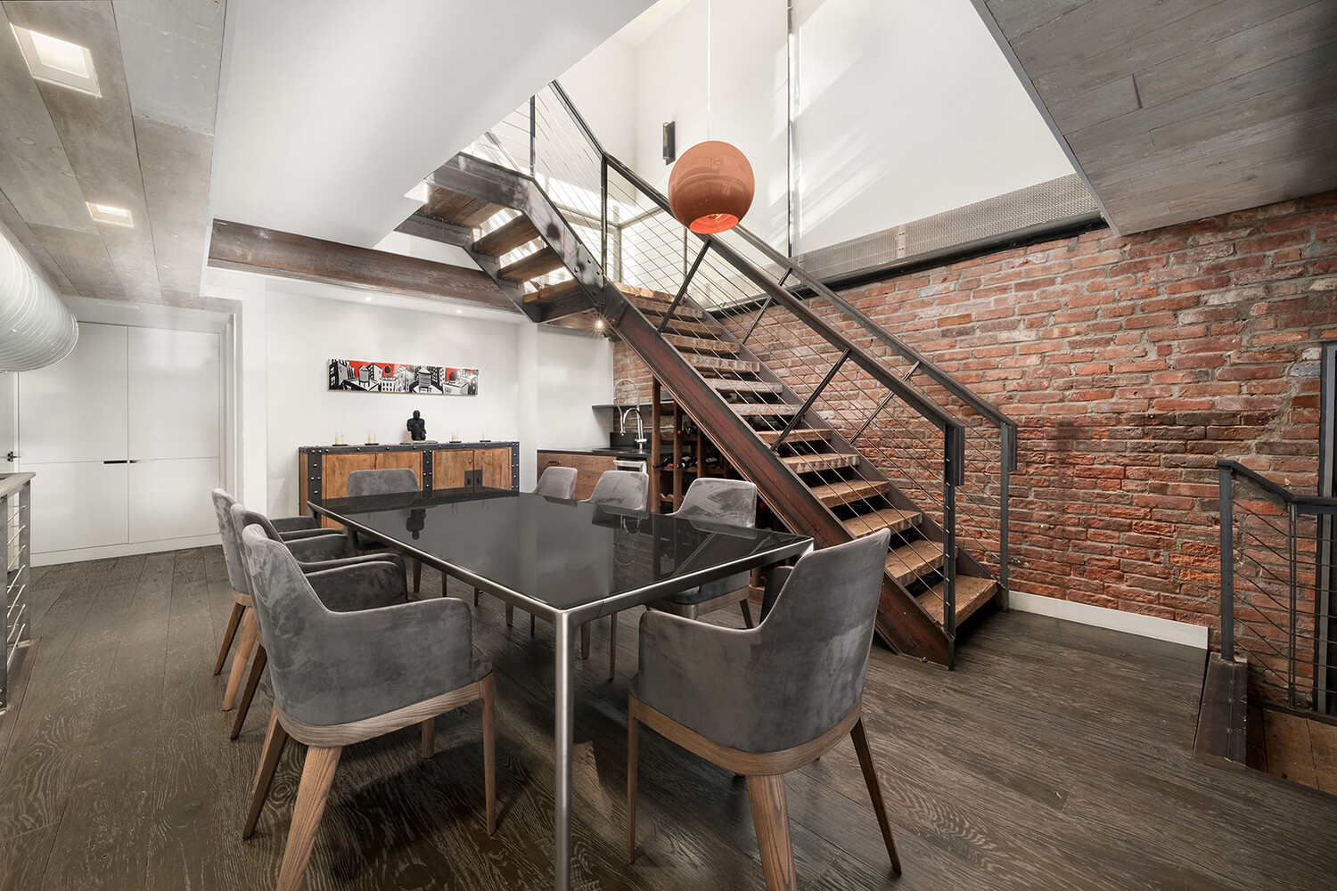 58 Walker Street, Unit PH Manhattan, NY 10013 - Photo 6 of 18 a dining room with wooden floor and stairs