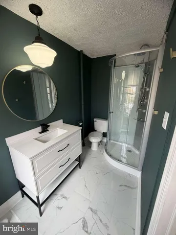 a bathroom with a sink a light fixture and a table