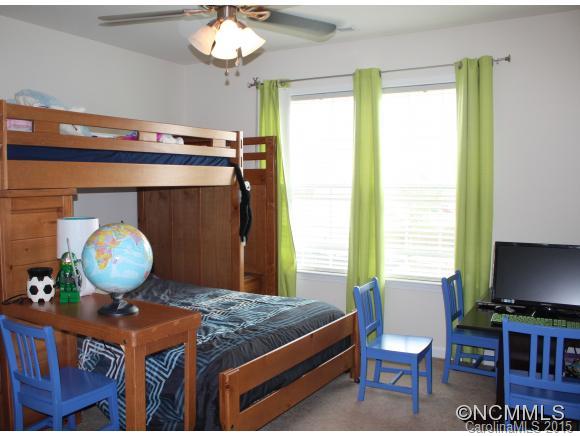 277 Roanoke Road Fletcher, NC 28732 - Photo 13 of 24 a bedroom with a bed and a chandelier