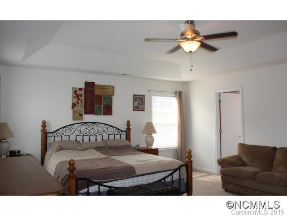 277 Roanoke Road Fletcher, NC 28732 - Photo 16 of 24 a bedroom with a bed window and a couch