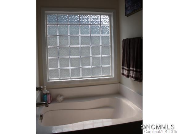277 Roanoke Road Fletcher, NC 28732 - Photo 17 of 24 a bathroom with a bathtub and a window