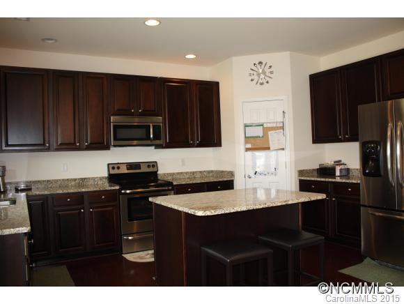 277 Roanoke Road Fletcher, NC 28732 - Photo 7 of 24 a kitchen with a sink a stove top oven and refrigerator