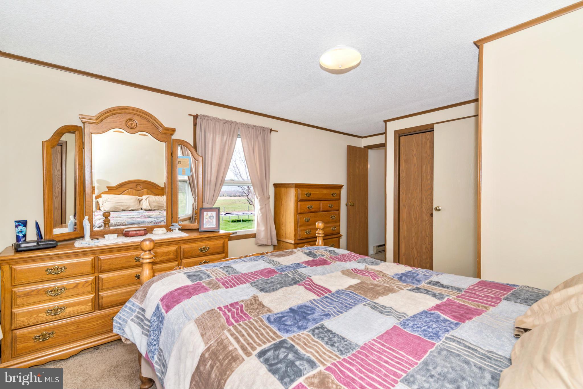 14120 Old Frederick Road Rocky Ridge, MD 21778 - Photo 22 of 30 a bedroom with a bed and a large window