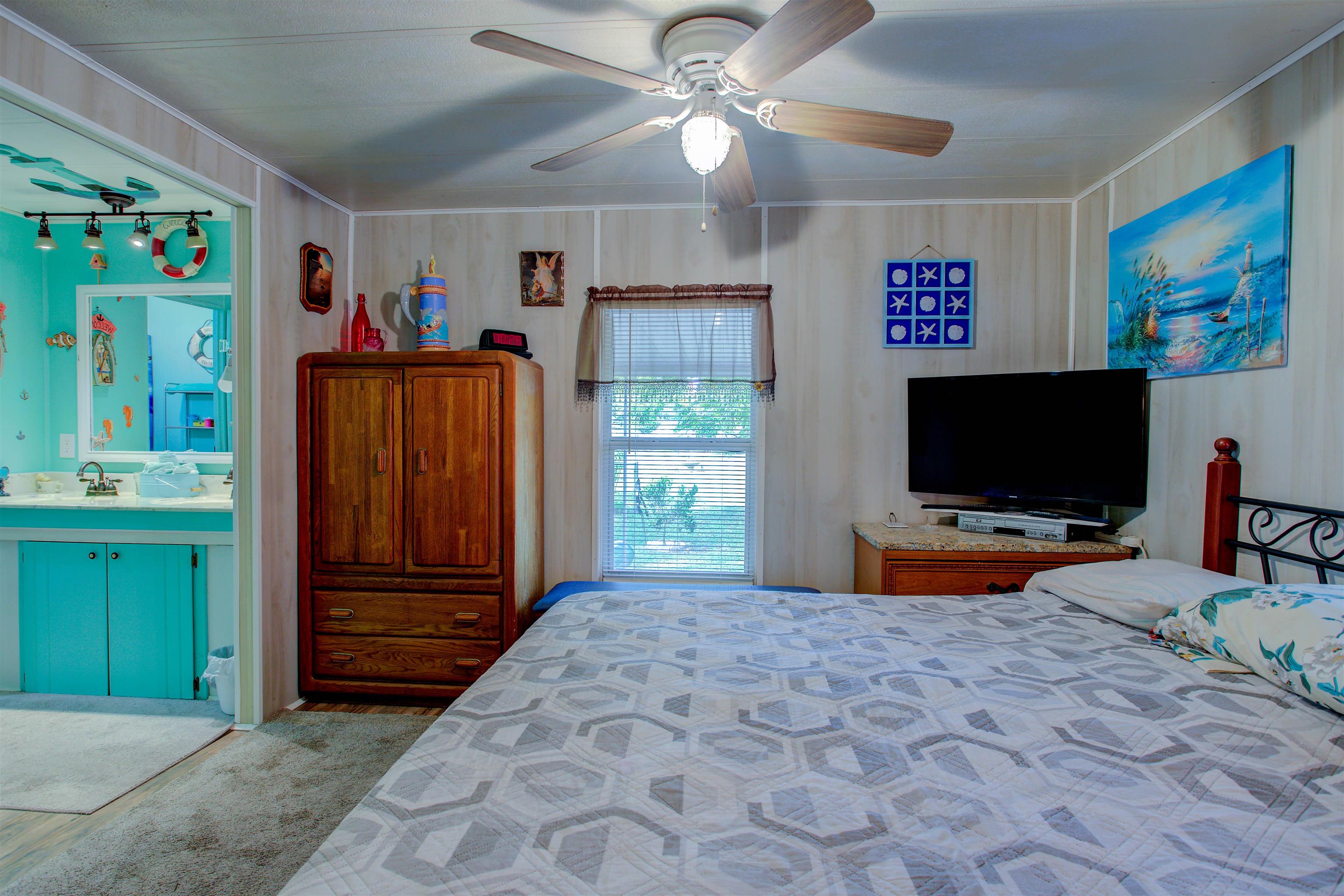 736 San Mateo Road Satsuma, FL 32189 - Photo 13 of 41 a bedroom with furniture and a flat screen tv