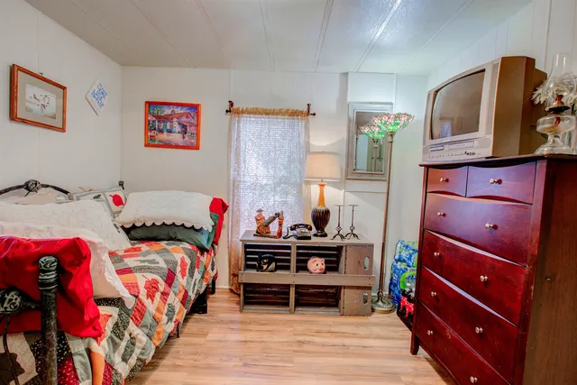 a bedroom with a bed and a dresser in it