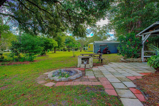 a view of a chair and table in the garden