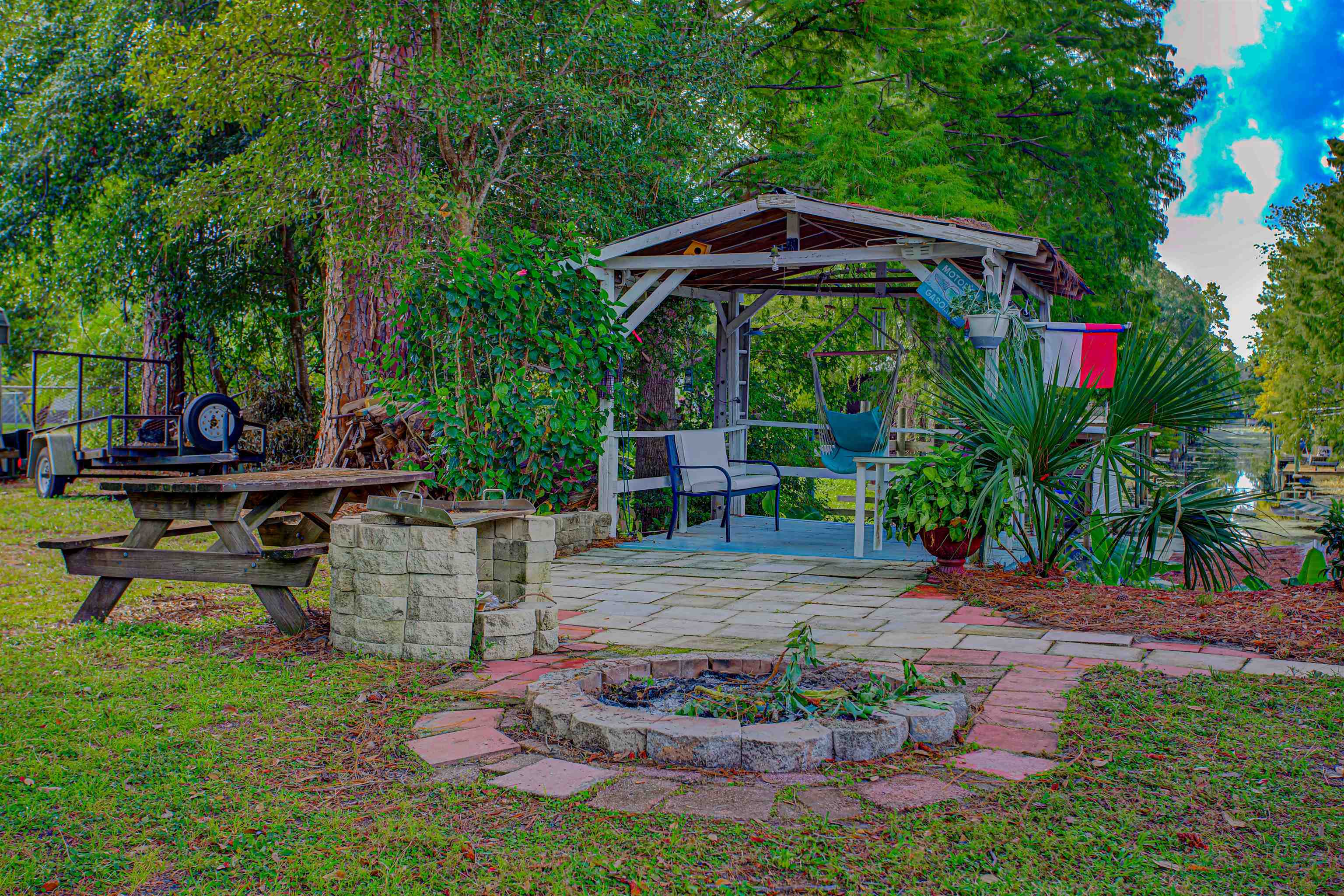 736 San Mateo Road Satsuma, FL 32189 - Photo 28 of 41 a view of a chair and table in the garden