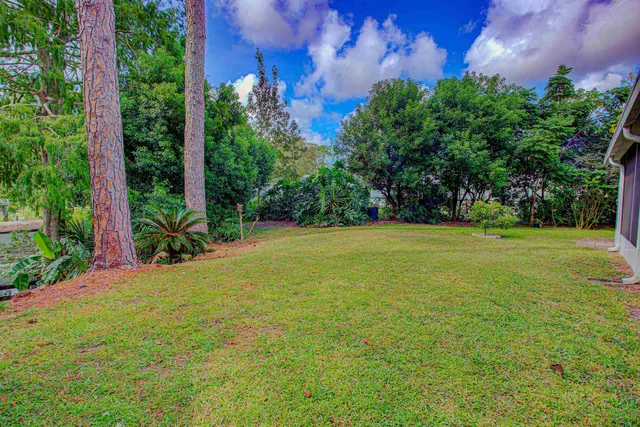 a view of a backyard with sitting area