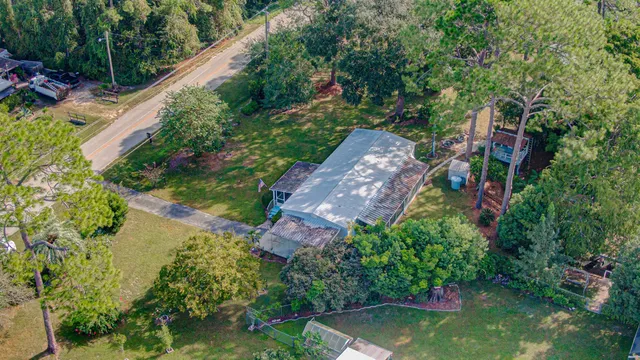 a view of a wooden deck with chairs and a yard