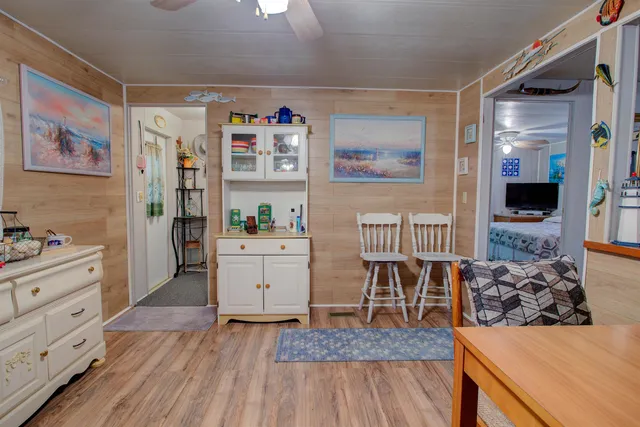 a kitchen with furniture and wooden floor