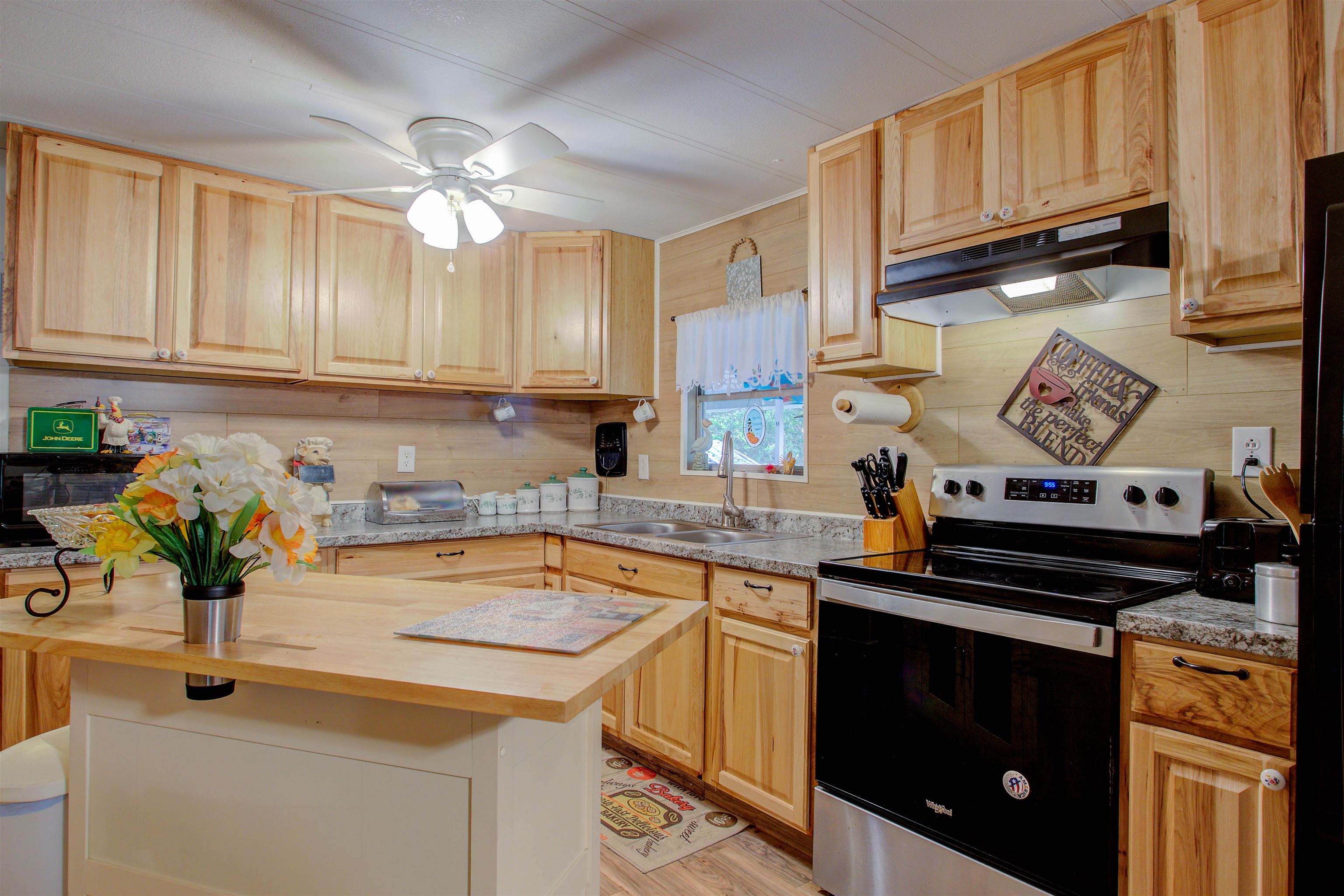 736 San Mateo Road Satsuma, FL 32189 - Photo 9 of 41 a kitchen with stainless steel appliances granite countertop a sink stove and cabinets