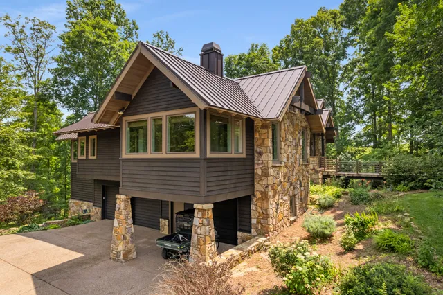 a large kitchen with a large counter top stainless steel appliances and cabinets