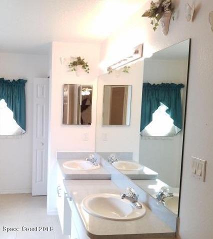 6157 Dees Road Cocoa, FL 32927 - Photo 12 of 20 a bathroom with a sink and a mirror