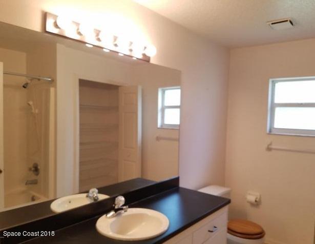 6157 Dees Road Cocoa, FL 32927 - Photo 15 of 20 a bathroom with a granite countertop sink and a mirror