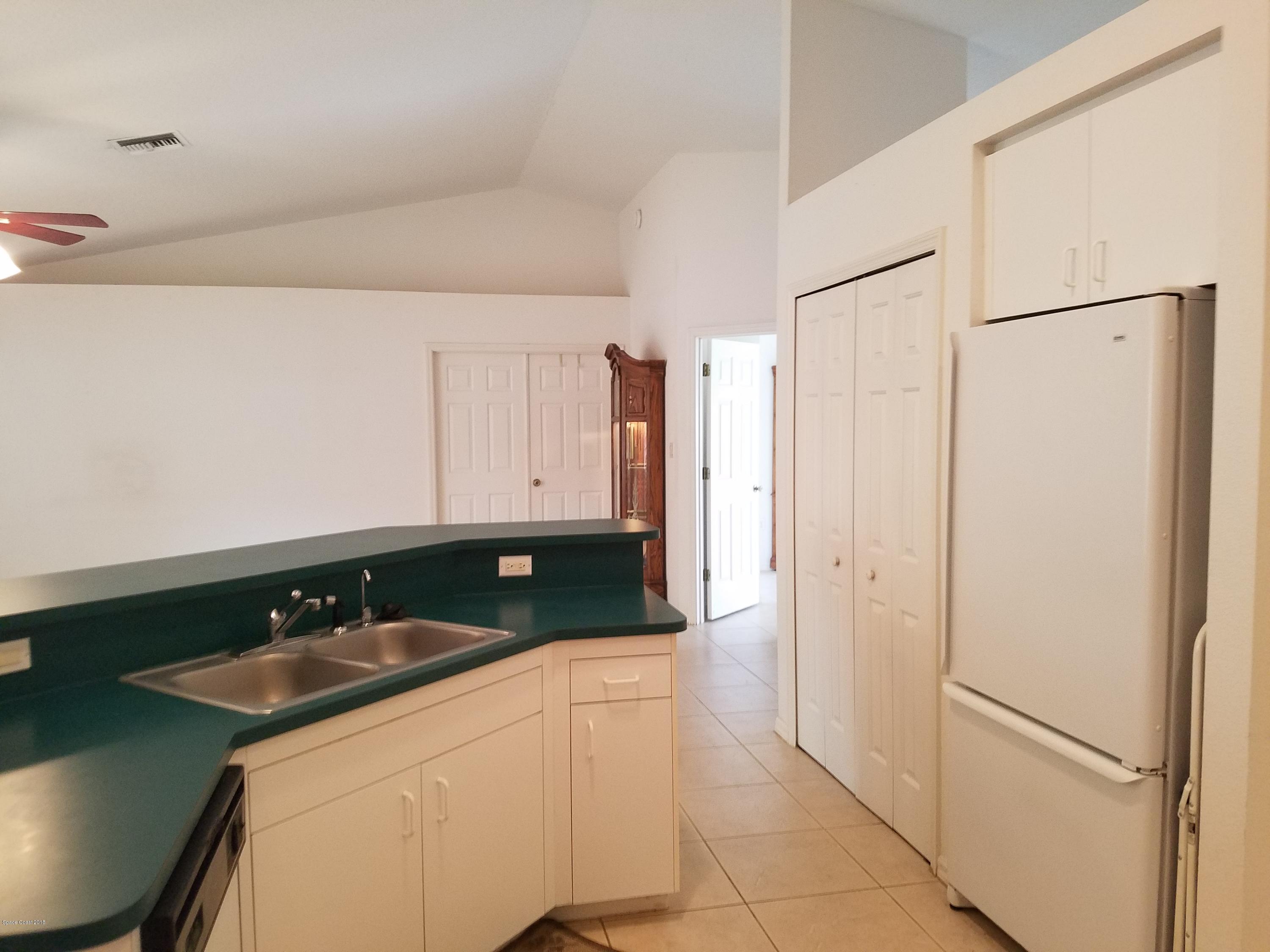 6157 Dees Road Cocoa, FL 32927 - Photo 4 of 20 a kitchen with stainless steel appliances granite countertop a refrigerator and a sink