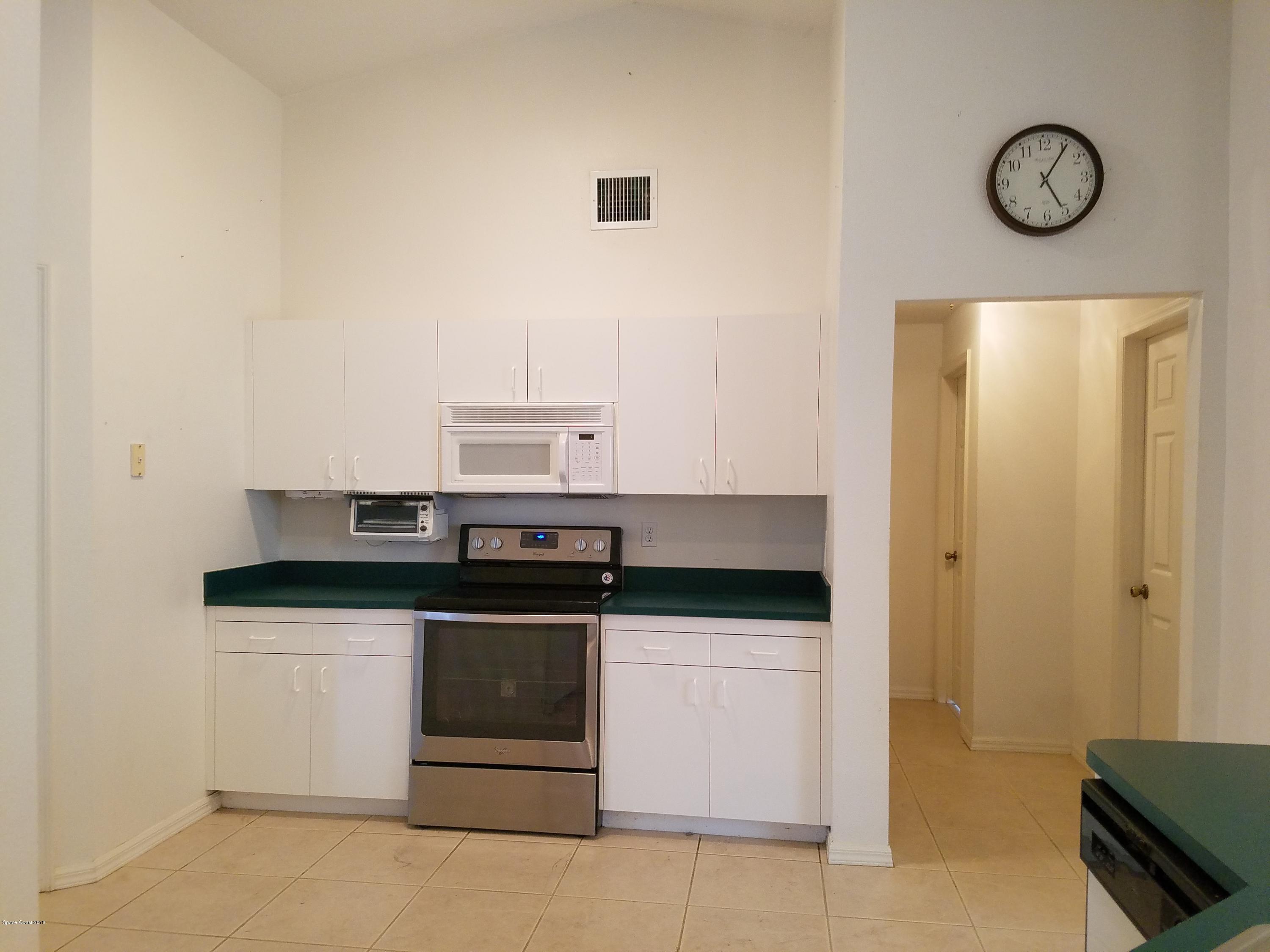 6157 Dees Road Cocoa, FL 32927 - Photo 5 of 20 a kitchen with stainless steel appliances granite countertop a stove and a refrigerator