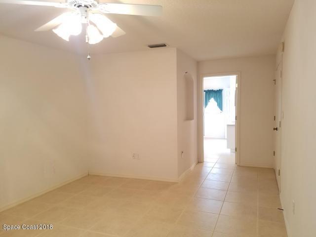 6157 Dees Road Cocoa, FL 32927 - Photo 10 of 20 a view of an empty room and chandelier fan