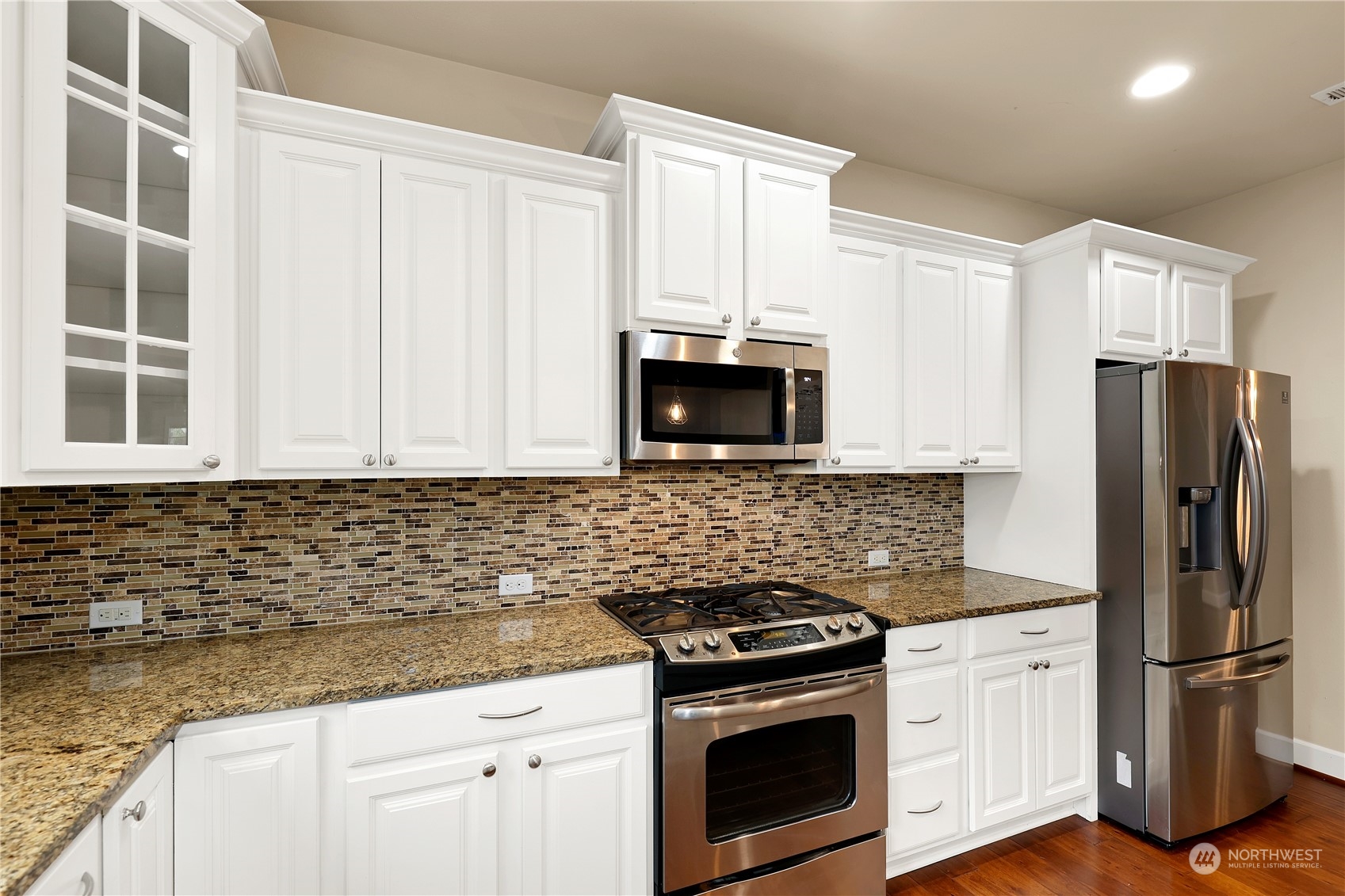 1592 Ridgeview Loop Southwest Tumwater, WA 98512 - Photo 11 of 40 a kitchen with granite countertop white cabinets stainless steel appliances and a sink