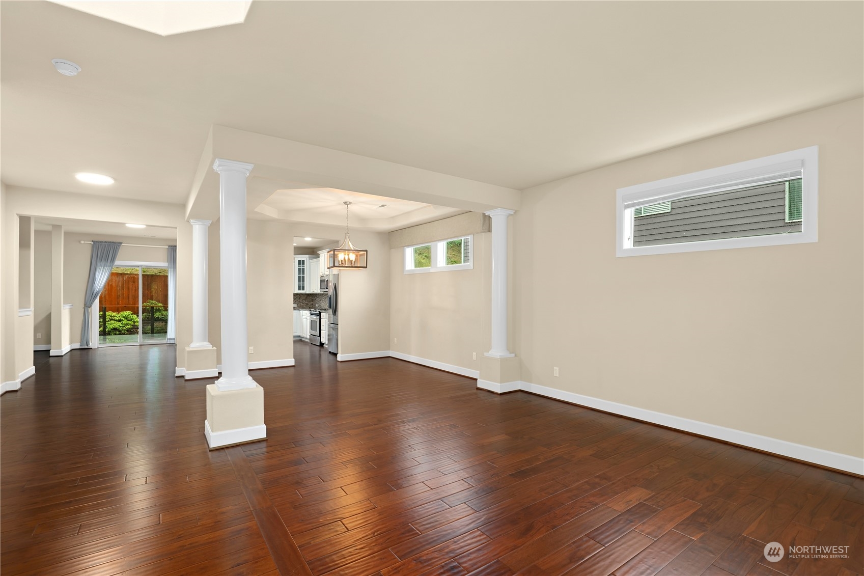 1592 Ridgeview Loop Southwest Tumwater, WA 98512 - Photo 13 of 40 a view of an empty room with wooden floor and a large window