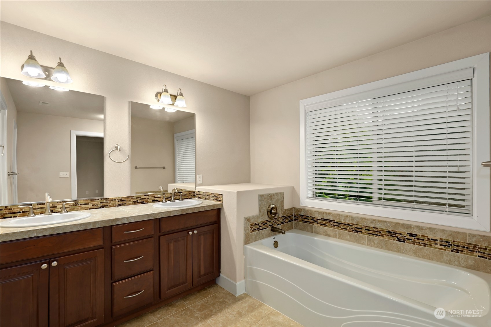 1592 Ridgeview Loop Southwest Tumwater, WA 98512 - Photo 25 of 40 a bathroom with a granite countertop sink mirror and a bathtub