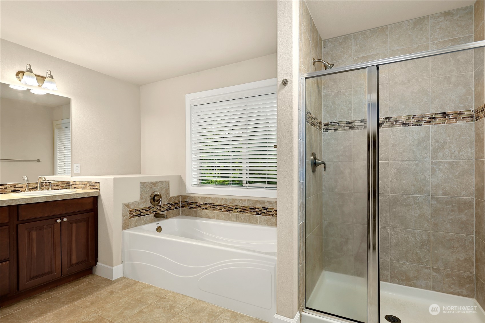 1592 Ridgeview Loop Southwest Tumwater, WA 98512 - Photo 26 of 40 a bathroom with a granite countertop tub sink and mirror