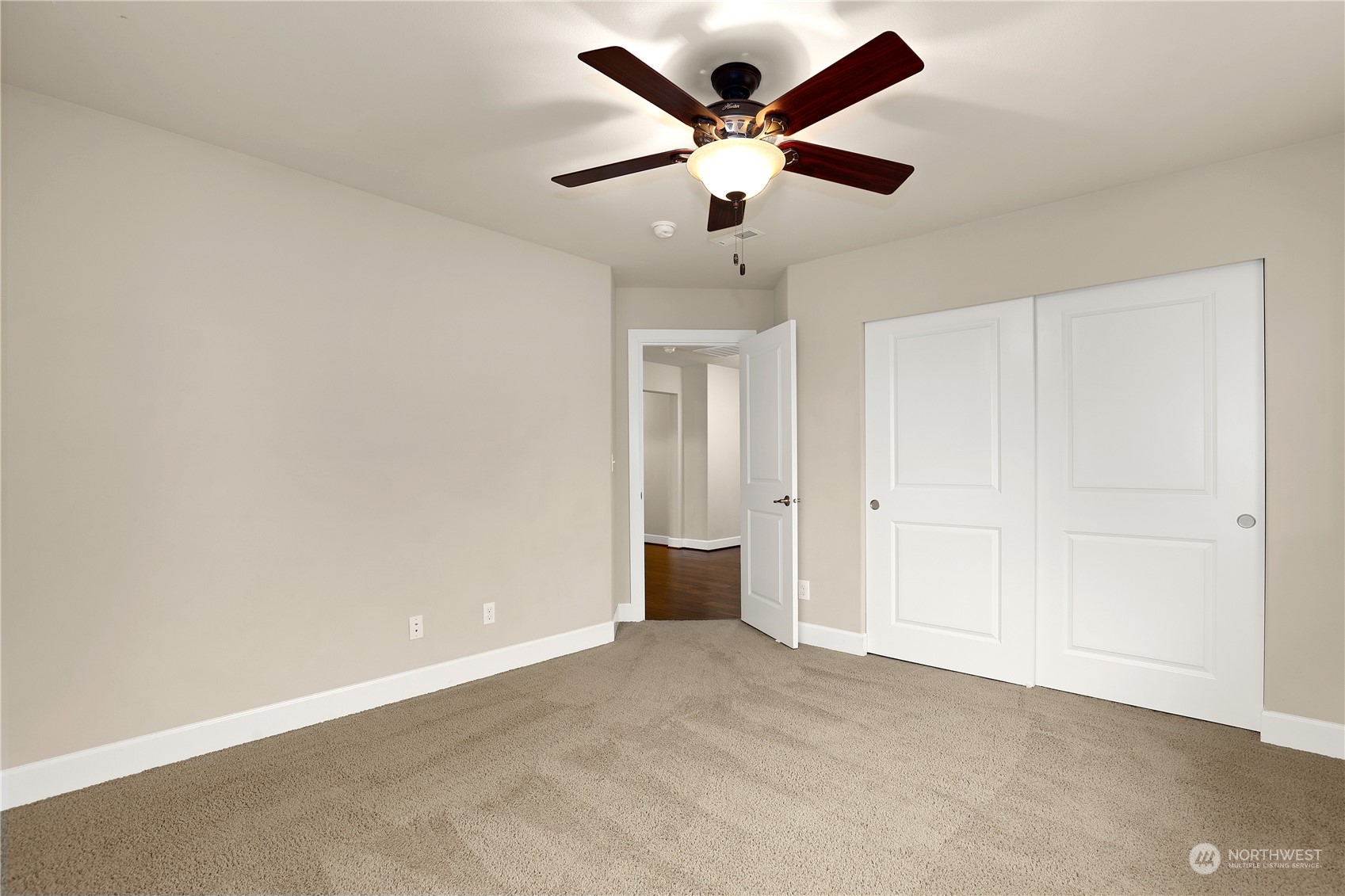1592 Ridgeview Loop Southwest Tumwater, WA 98512 - Photo 28 of 40 an empty room with a ceiling fan and carpet