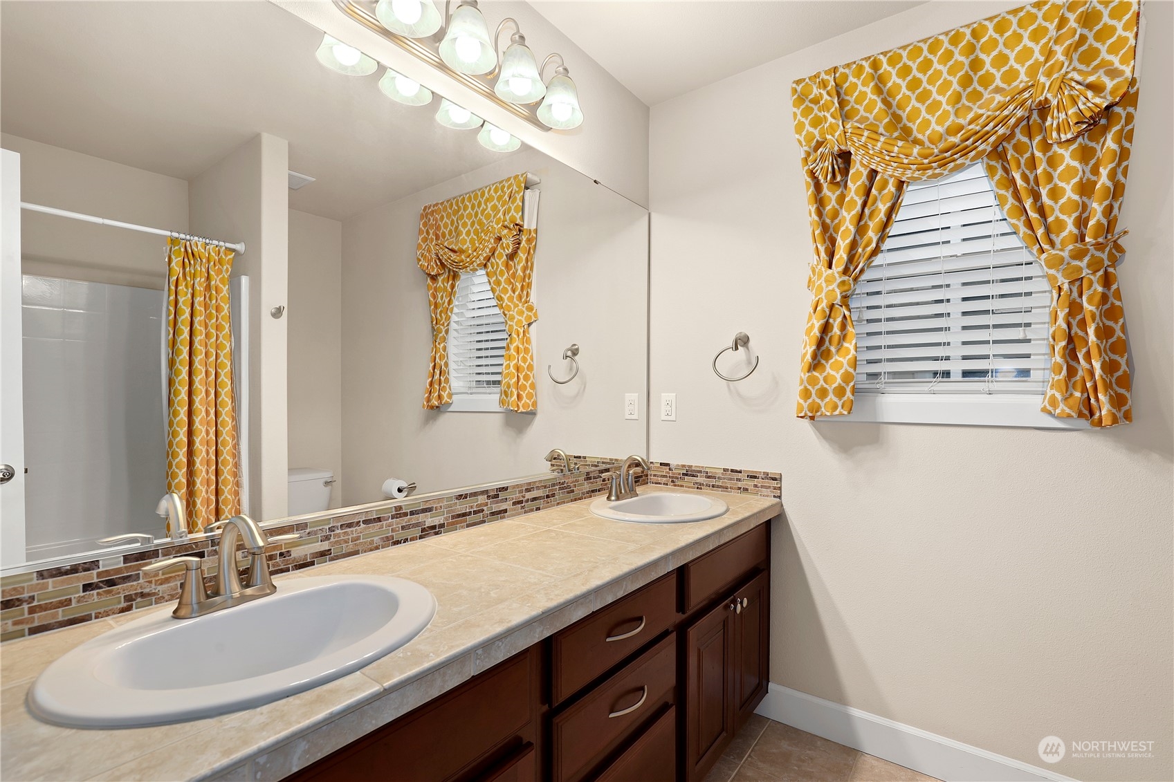 1592 Ridgeview Loop Southwest Tumwater, WA 98512 - Photo 29 of 40 a bathroom with a granite countertop sink and a mirror