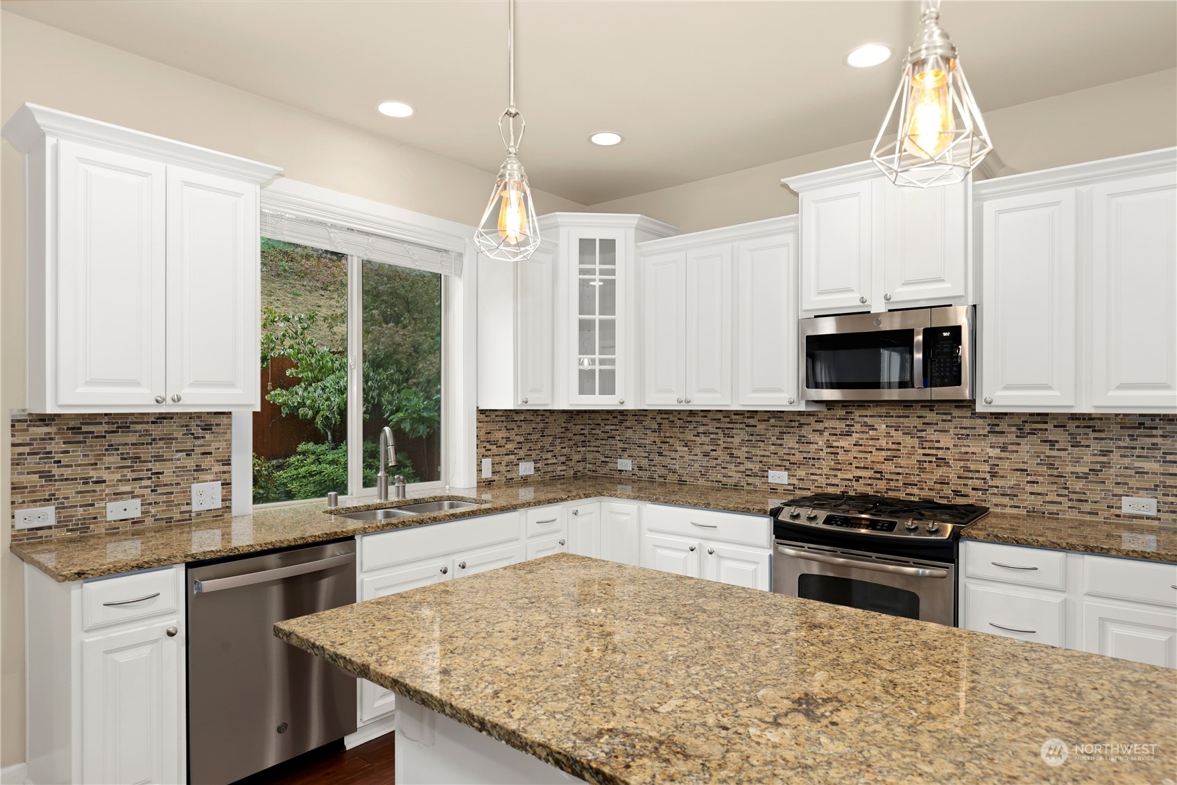 1592 Ridgeview Loop Southwest Tumwater, WA 98512 - Photo 8 of 40 a kitchen with stainless steel appliances granite countertop a sink a stove and oven