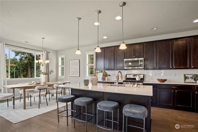 a kitchen with lots of counter space a sink and appliances
