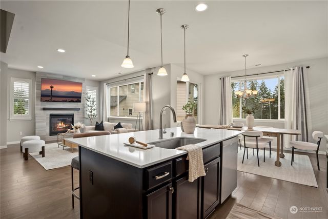 a open kitchen with sink dining table and chairs