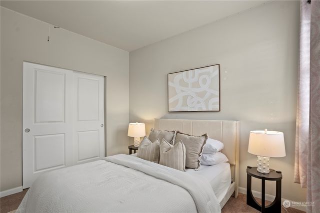 a bedroom with bed and night stand