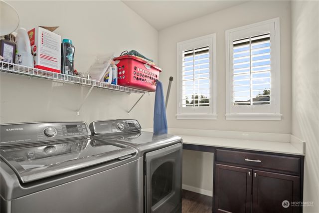 a utility room with sink dryer and washer