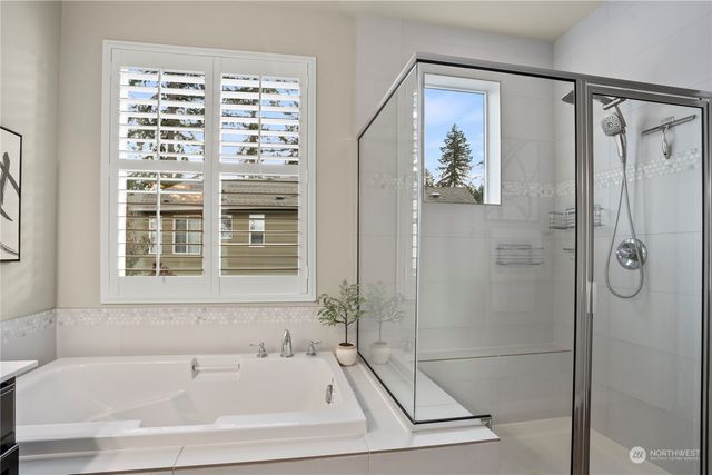 a bathroom with a bathtub and a shower
