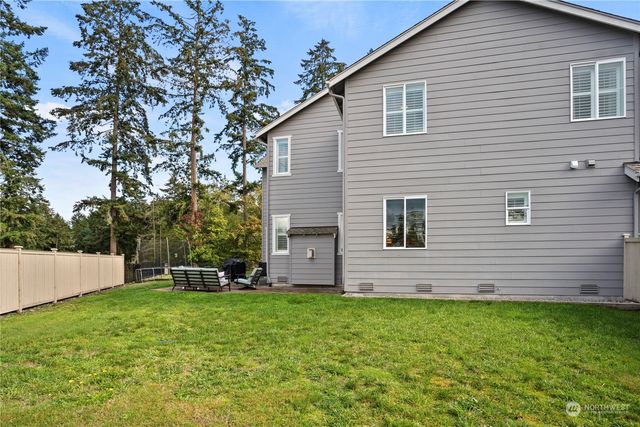 a view of a backyard with table and chairs