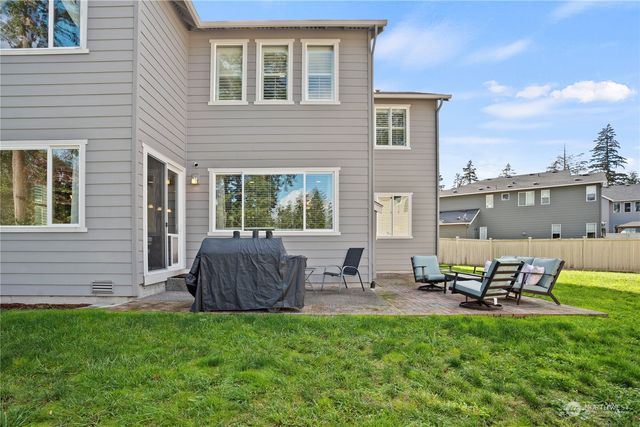 a view of a house with backyard tub and sitting area