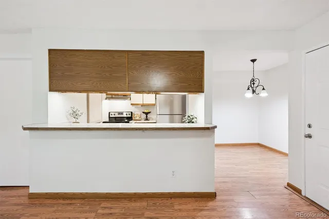 a kitchen with a sink and wooden floor